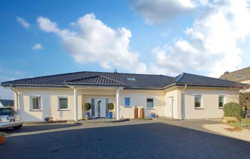 a white house with a black roof at 2 Bedroom Stunning Home In Arzfeld in Arzfeld