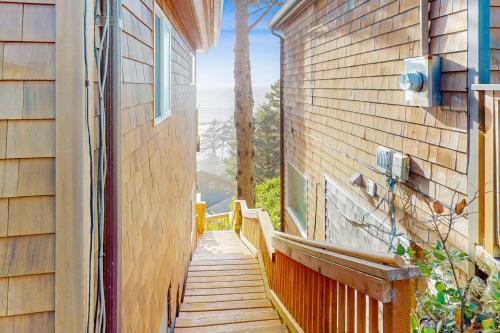 a wooden walkway leading up to a house with a window at La Petite Maison in Oceanside
