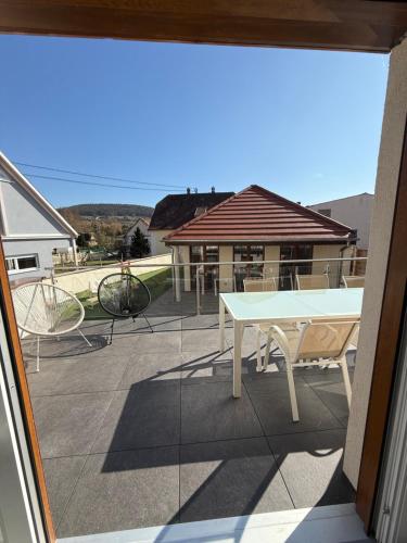 a view of a patio with a table and chairs at L ecrin de Rosheim, villa d exception, piscine in Rosheim