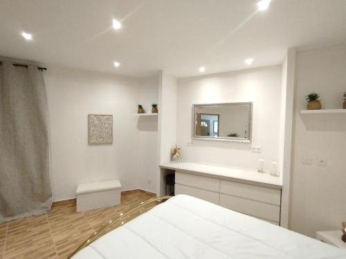 a white bathroom with a sink and a mirror at Charmant Appartement en Provence in Caromb