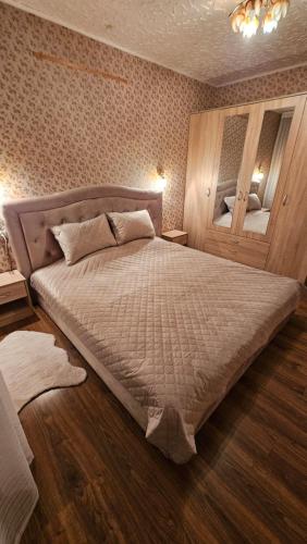 a bedroom with a large bed in a room at Celtnieku 14 in Ventspils
