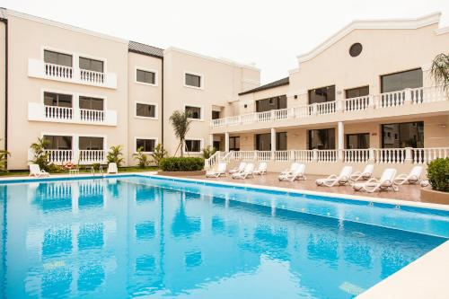 a swimming pool in front of a building at Howard Johnson Hotel & Casino in Formosa