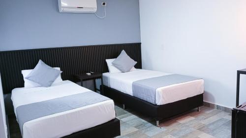 Postel nebo postele na pokoji v ubytování Hotel Palmas del Estadio