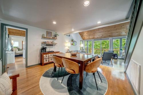 a kitchen and dining room with a wooden table and chairs at Chic Cabin with 3 Kings Privacy & Pool Access in Hedgesville