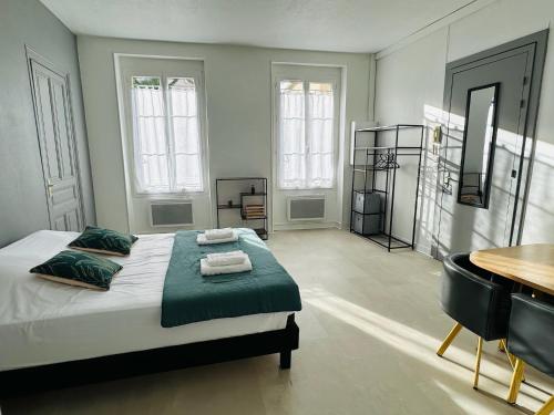 une chambre avec un lit, une table et un bureau dans l'établissement Studio 1 Proche Centre Ville Wifi et Parking Troyes, à Troyes