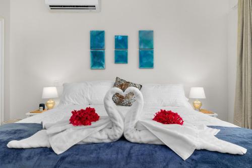 two swans making a heart on a bed at Aruba Breeze C4 in Palm-Eagle Beach