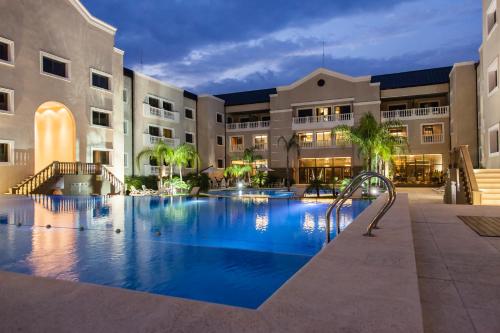 a swimming pool in the middle of a building at Howard Johnson Hotel & Casino in Formosa