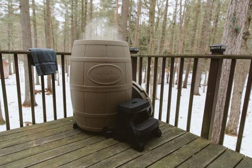 a large appliance sitting on a wooden deck at Cozy Cabin near Lake Placid, Whiteface-King, Ice Barrel, Hot Tub in Jay