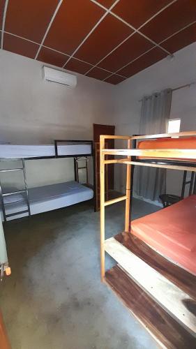 a room with several bunk beds in it at Rancho de Pedro in El Viejo