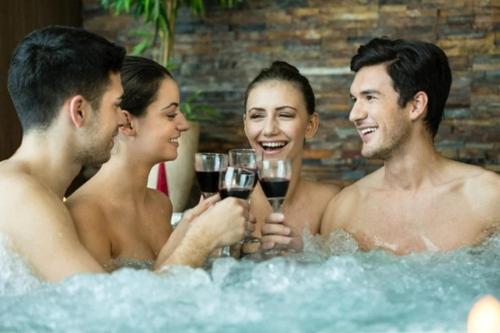a group of people drinking wine in a bathtub at Domaine les 2 Mondes in Aydat