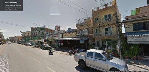 a white truck parked on the side of a city street at Bann Lom Le Guest House in Hua Hin