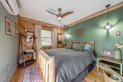 a bedroom with a bed and a green wall at Upscale w Fireplace Fire Pit Games in Gated Comm in Paw Paw
