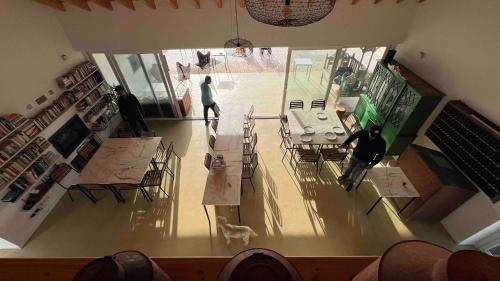 an overhead view of a living room with people and a dog at Vale das Estrelas in São Teotónio