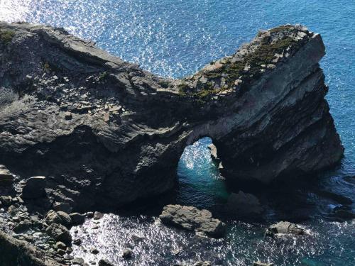 a rock formation in the water near the ocean at Vale das Estrelas in São Teotónio