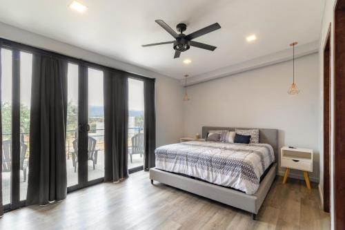 a bedroom with a bed and a ceiling fan at Vineyard l Privacy l Terrace l BBQ l Playground FINCA MD in Ensenada