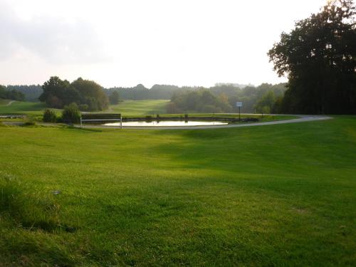 a view of a golf course with a green field at Ferienwohnung Sommer in Sankt Wendel