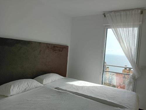 a bedroom with a bed with a large window at Luxury Apartment MonacoView in Beausoleil