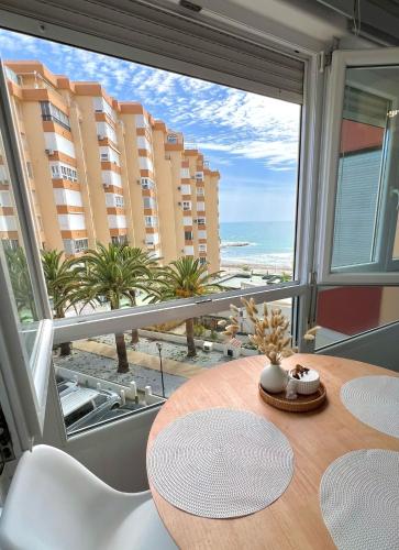 a dining room with a table and a view of the ocean at Apartamento Turistico Peñalver Playa 316 in Torrox Costa