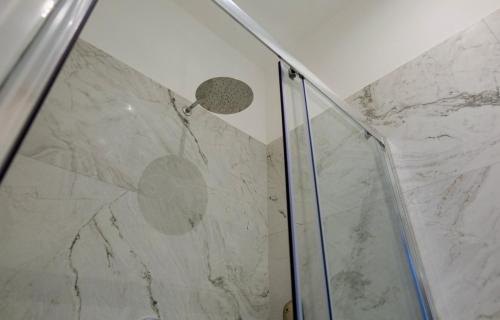 a shower with a glass door in a bathroom at Relais Vittorio Veneto - Luxotel & Apartotel in Salerno