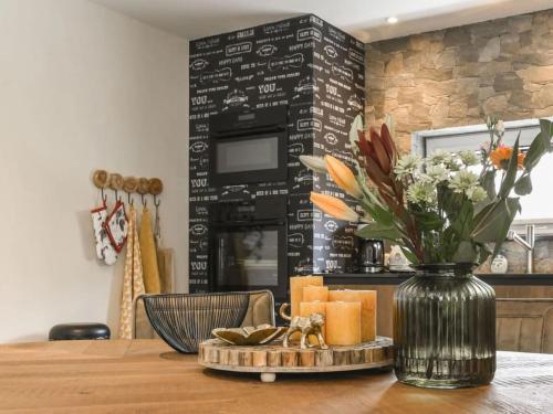 a dining room table with a vase of flowers and candles at Charming villa with garden in Rijs