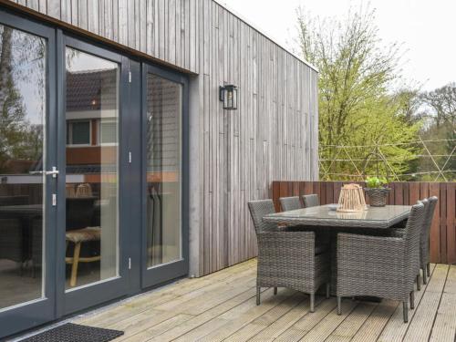 a patio with a table and chairs on a deck at Charming villa with garden in Rijs