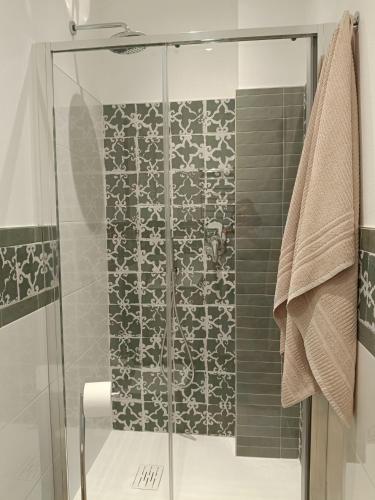 a shower with a glass door in a bathroom at Apartment/Studio il Girasole in Rapallo