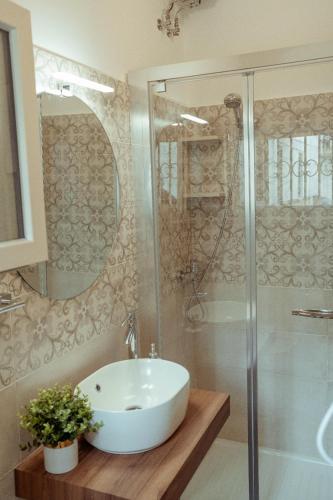 a bathroom with a white sink and a shower at Casa Vacanza Il Piccolo Principe in Ginosa