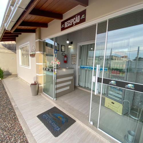 a store front with a glass entry door with aperature at Pousada Rota dos Mares in Penha