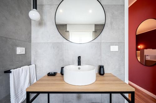 a bathroom with a white sink and a mirror at - NumberZ - Rooms Apartments and Suites with Wi-Fi and AC in Borgo Isonzo