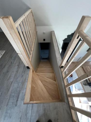 a staircase in a house with wooden floors at Le Paradis 210 m2 en pleine nature in Cambrai