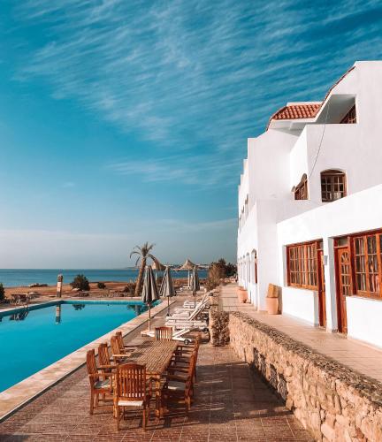 a resort with a swimming pool and the ocean at Serenity Lodge in Sharm El Sheikh