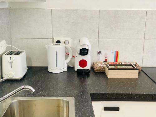 a kitchen counter with various appliances on it at Studio calme et lumineux à Uccle in Brussels