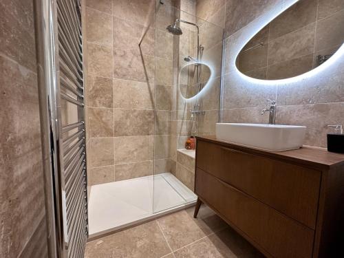 a bathroom with a shower and a sink and a mirror at Casa Mia Moneghetti in Beausoleil