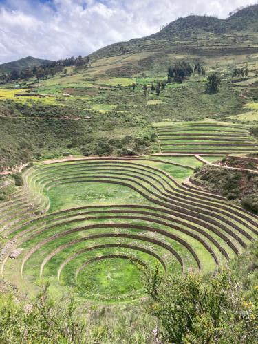 an amphitheater in a field with mountains in the background at La Maison Samaï in Urubamba