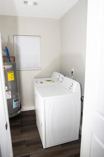 a laundry room with a white washer and a window at Modern 4BR Home Great Location Spacious in Conyers