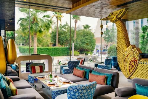 a restaurant with a giraffe hanging from the ceiling at The Ritz-Carlton, Bahrain in Manama