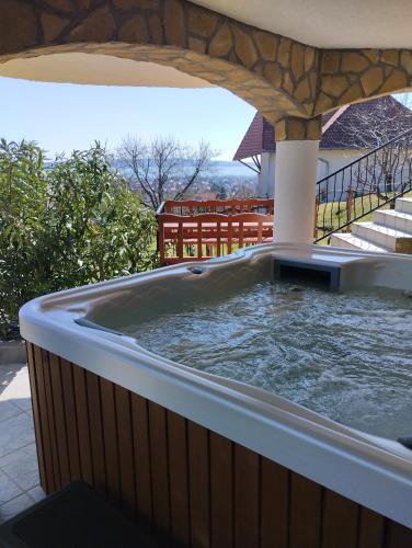 a hot tub on the patio of a house at Harmónia Vendégház in Vonyarcvashegy