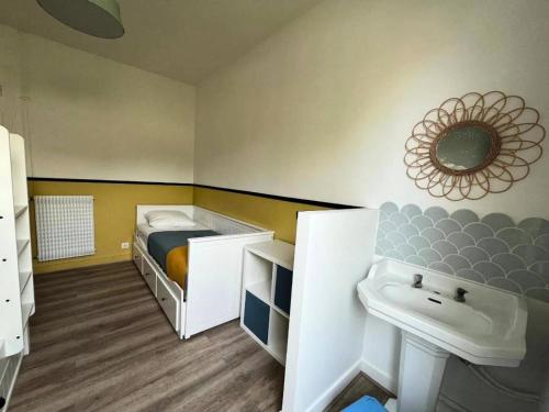 une petite chambre avec un lit et un lavabo dans l'établissement Résidence 401-arcachon - Maison familiale de charme avec jardin, à deux pas de la plage de Joigny MAE-8871, à Arcachon
