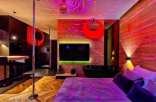 a bedroom with a bed and a tub and a tv at LupoApartments z Klimatyzacją do wyboru z Jacuzzi Pole Dance Parking Dostęp na Kod in Łódź