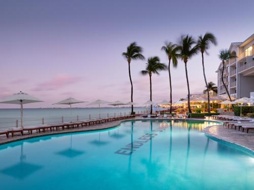 a swimming pool with palm trees and a hotel at Grand Cayman Marriott Resort in George Town