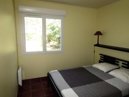 une chambre avec un lit et une fenêtre dans l'établissement Résidence Het Club - Maison 3 chambres, 6 pers au sein d'une résidence avec piscine à Lacanau océan MAE-0471, à Lacanau