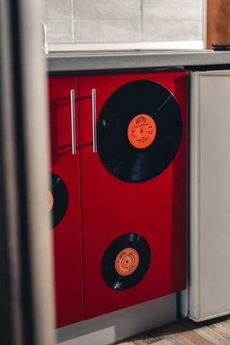 a red cabinet with two vinyl records on it at Penzion Hádlík in Velké Pavlovice