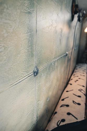 a close up of a metal wall with a table at Penzion Hádlík in Velké Pavlovice
