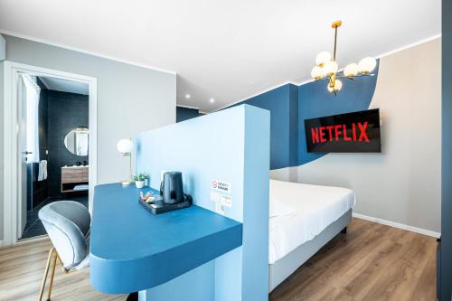 a hotel room with a bed and a blue desk at - NumberZ - Rooms Apartments and Suites with Wi-Fi and AC in Borgo Isonzo
