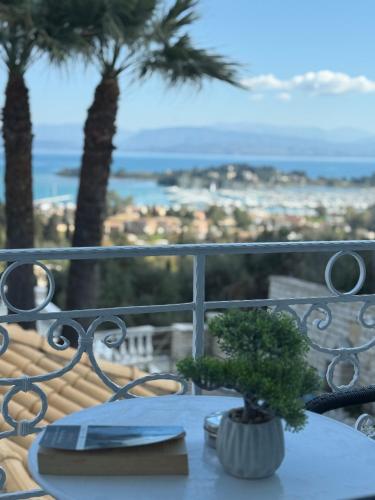 a table on a balcony with a view of the ocean at La Vista Residence - 5 BDS, 2 private swimming pools, stunning sea views only 10 minutes from Corfu Town's Centre in Gouvia