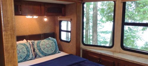 a bedroom with a bed and two windows in it at Lakefront! Twin Birch Resort - The Loon in Honor