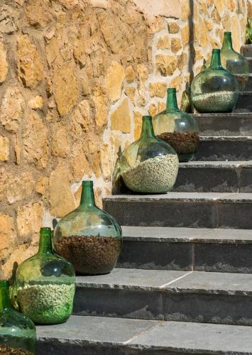 a row of green vases sitting on steps at Hostal Foies de Baix in Relleu