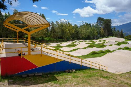 a skate park with a skateboard ramp in a field at Hostal las margaritas in Pasto