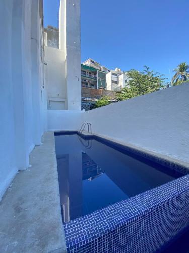 a swimming pool on the side of a building at VILLA COSTERA HOTEL BOUTIQUE in Acapulco