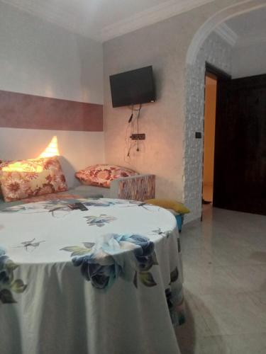 a bedroom with a bed and a tv on the wall at Saidia appartments in Saïdia